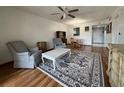 Inviting living room with hardwood floors, ceiling fan, and classic furniture at 11485 Oakhurst Rd # 319, Largo, FL 33774