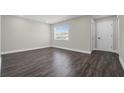 Bright bedroom featuring dark wood floors, neutral walls, and natural light at 1204 Croydonwood Cir, Brandon, FL 33510