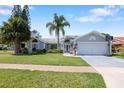 Charming one-story home featuring a well-maintained lawn and a spacious two-car garage at 13528 Woodside Dr, Hudson, FL 34667