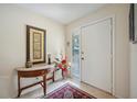 Bright foyer with tile flooring, a decorative table, and a storm door for added security at 150 James Ct, Oldsmar, FL 34677
