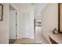 Hallway showcasing tile flooring, coat closet, and an open view into the living spaces at 150 James Ct, Oldsmar, FL 34677