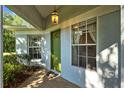 Inviting front entrance with a decorative green door, sidelight windows, and brick walkway at 26306 Whirlaway Ter, Wesley Chapel, FL 33544