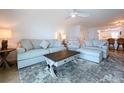 Inviting living room with plush seating, a stylish coffee table, and a view of the eat-in kitchen at 2675 St Josephs E Dr # C, Dunedin, FL 34698