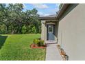 Inviting front door with sidelights and well manicured yard at 2821 Lytton Hall Dr, Zephyrhills, FL 33540