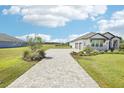 Long paved driveway leading to a well-maintained one-story home with a three-car garage at 32860 Drake Estates Way, Dade City, FL 33525
