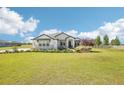 Charming one-story home featuring stone accents, manicured landscaping, and a spacious green lawn at 32860 Drake Estates Way, Dade City, FL 33525