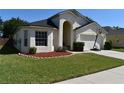 Charming home with a well-maintained lawn and appealing landscaping details at 3414 Berry Blossom Ln, Plant City, FL 33567