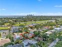Lovely aerial view of home with views of the local lake and the St. Petersburg skyline at 349 Belleair Ne Dr, St Petersburg, FL 33704