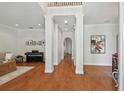 Spacious foyer featuring hardwood floors, high ceilings, architectural columns, and an open floor plan at 3710 W San Pedro St, Tampa, FL 33629