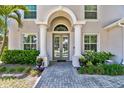 Close-up of front entrance with double doors, columns, an arched transom, and a paved walkway at 3710 W San Pedro St, Tampa, FL 33629