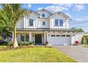 Beautiful two-story modern farmhouse with well-manicured lawn, black metal roof, and attractive driveway at 3821 W Vasconia St, Tampa, FL 33629