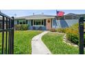 Close up of a well-maintained, light blue house with neat landscaping and pathway to the front door at 4013 W Waterman Ave, Tampa, FL 33609