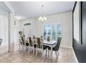 Dining room featuring a long table, shuttered windows, and ceramic tile flooring throughout at 41043 Stanton Hall Dr, Dade City, FL 33525
