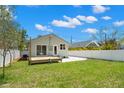 Large backyard with grassy lawn, wooden deck, and white privacy fence at 422 24Th N St, St Petersburg, FL 33713