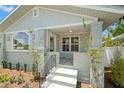 Inviting front porch features decorative tile flooring, painted brick and steps at 422 24Th N St, St Petersburg, FL 33713