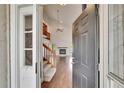 View from doorway into the living room with wood floors, vaulted ceilings, and natural light at 4225 Barret Ave, Plant City, FL 33566