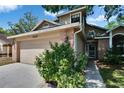 Charming two-story home with a two car garage, brick accents, and mature landscaping at 4225 Barret Ave, Plant City, FL 33566