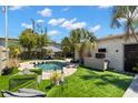 Backyard oasis featuring a pool, bar, outdoor seating, lush landscaping, and a privacy fence at 4829 20Th N Ave, St Petersburg, FL 33713