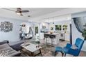 Open-concept living room and kitchen featuring a hanging chair, breakfast bar, and modern design elements at 5254 23Rd N Ave, St Petersburg, FL 33710