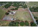 Expansive property boasts a ranch-style house, horse stables, and a sizable lot outlined in red at 6709 W Knights Griffin Rd, Plant City, FL 33565