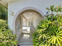 A charming gated entrance leads into the home's courtyard amidst lush landscaping at 7307 Summerbridge Dr, Tampa, FL 33634