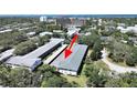 A condo building with covered parking nestled amidst verdant trees, offering a serene living environment at 100 Glennes Ln # 108, Dunedin, FL 34698