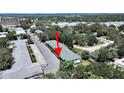 Charming condo building surrounded by lush greenery with parking, providing a peaceful community atmosphere at 100 Glennes Ln # 108, Dunedin, FL 34698