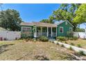 Home's exterior features a covered front porch and mature landscaping at 1046 Yale N St, St Petersburg, FL 33713