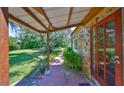 Inviting covered porch featuring stone accents and a well-manicured yard at 10824 Palmetto St, Riverview, FL 33569
