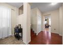 Inviting entryway with tile flooring, wood stairs and trim, storage closet, and views into adjacent living spaces at 1227 Ballard Green Pl, Brandon, FL 33511