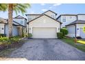 View of home with a 2 car garage and a brick driveway at 1227 Ballard Green Pl, Brandon, FL 33511