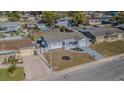Aerial view of a residential home with a fenced backyard and a swimming pool in the neighborhood at 1264 Chelsea Ln, Holiday, FL 34691