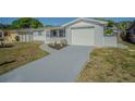 Charming single-story home with a screened-in porch and an attached garage with a driveway at 1264 Chelsea Ln, Holiday, FL 34691