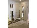 Inviting foyer with neutral tile, decorative accents, and closet storage at 12920 Wedgewood Way # A, Hudson, FL 34667