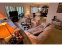 Comfortable living room flows into the dining area with ample seating at 12920 Wedgewood Way # A, Hudson, FL 34667