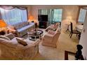 Cozy living room featuring plush furniture and natural light at 12920 Wedgewood Way # A, Hudson, FL 34667