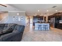 Open-concept living space with tile floors, dark cabinetry, and a cozy living area with lots of space at 13639 Ashlar Slate Pl, Riverview, FL 33579
