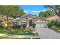 Inviting single-Gathering home with lush lawn, manicured shrubs, and a two-car garage at 1518 Rolling Meadow Dr, Valrico, FL 33594