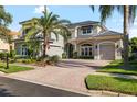 Beautiful two-story home with a brick driveway, lush landscaping, and a two-car garage at 16629 Sedona De Avila, Tampa, FL 33613