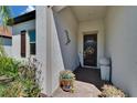 View of the covered front porch with beautiful tile flooring and decor at 17583 Holly Well Ave, Wimauma, FL 33598