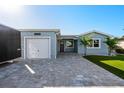 Charming home with a well-manicured lawn, paver driveway and attached one car garage at 17730 Long Point Dr, Redington Shores, FL 33708