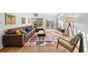 Cozy living room with hardwood floors, comfortable seating, and views of the canal at 17730 Long Point Dr, Redington Shores, FL 33708