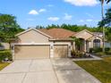 Exterior shot of the house with a large driveway and three car garage at 18310 Bankston Pl, Tampa, FL 33647