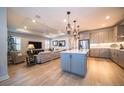 Open-concept kitchen with a center island, stainless steel appliances, and pendant lighting at 19442 Sea Glass Cir, Land O Lakes, FL 34638
