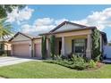 Charming single-Gathering home with a three-car garage and lush green lawn at 2127 Landside Dr, Valrico, FL 33594