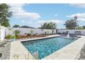 Beautiful backyard pool with a well-kept garden and privacy fence at 2127 Landside Dr, Valrico, FL 33594