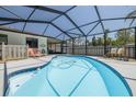Inviting pool area surrounded by a screened enclosure and a lounge area, perfect for outdoor relaxation and entertaining at 225 Cevera Dr, Dunedin, FL 34698