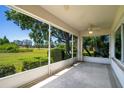 Relaxing screened patio with ceiling fan and expansive views of the landscaped backyard and blue sky at 2333 Brookfield Greens Cir, Sun City Center, FL 33573