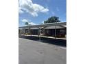 Apartment building with covered parking, showcasing brick facade and tidy landscaping on a bright day at 24862 Us Highway 19 N # 2303, Clearwater, FL 33763
