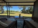 Relaxing covered patio with comfortable seating and a view of the lush green lawn at 24862 Us Highway 19 N # 2303, Clearwater, FL 33763